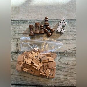 Bag of little mini trinkets. Scrabble letters some dice and wood chess pieces.